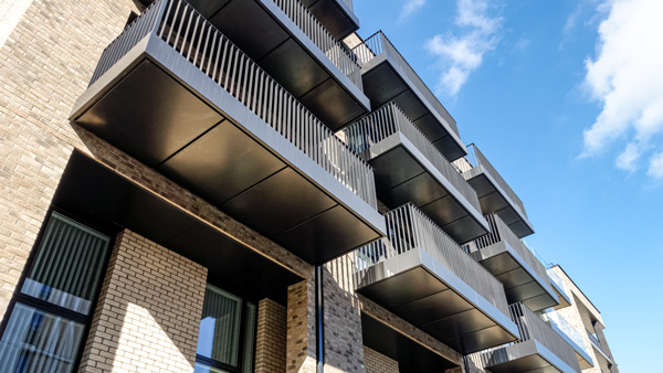 modern apartment building with black balconies sustainable design urban living