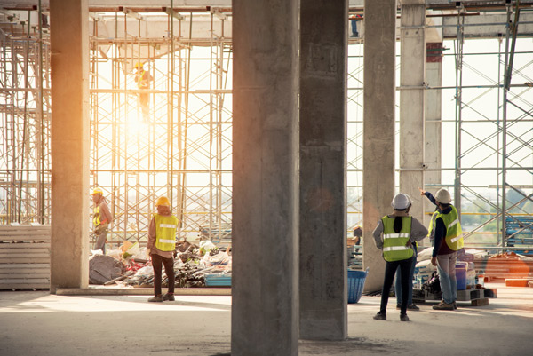 construction site with workers and scaffolding overseeing operations