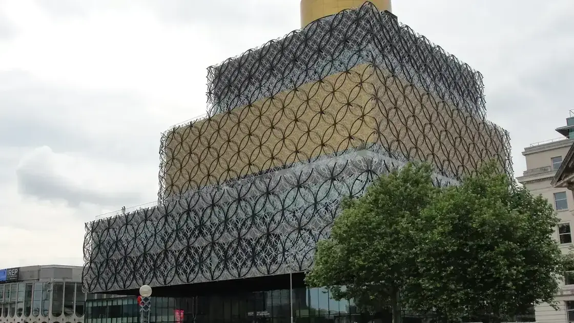 The patterned circular façade of the Library of Birmingham beside Centenary Square.
