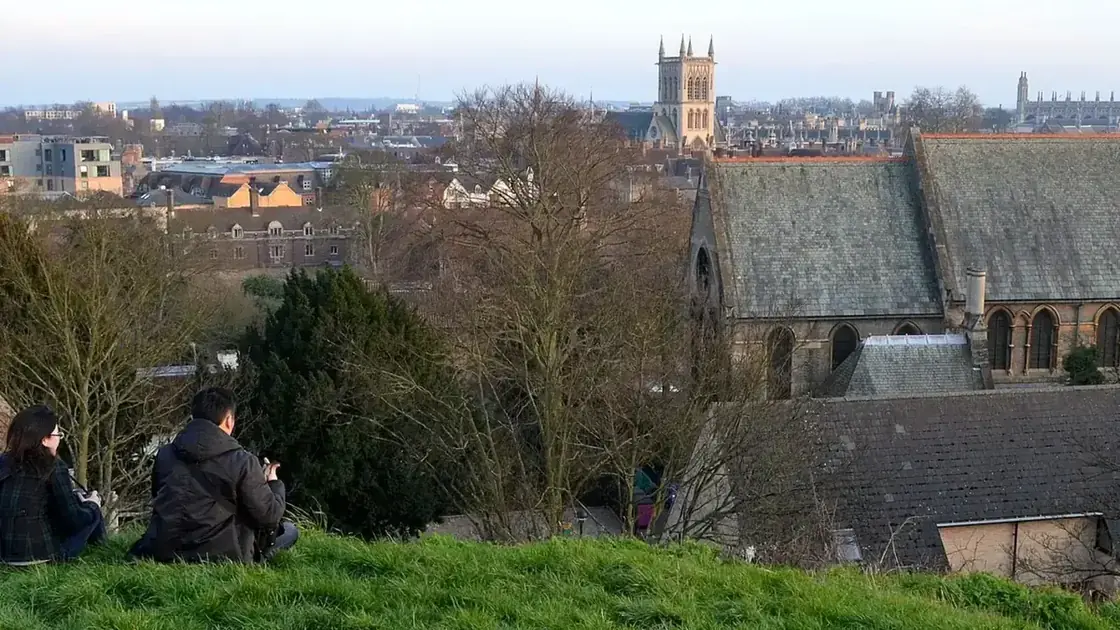 Cambridge's college towers and city skyline viewed across rooftops from Castle Mound.