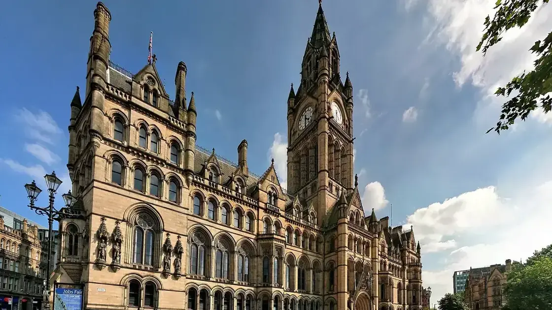 Manchester Town Hall's Gothic stone façade and clock tower seen from Albert Square.