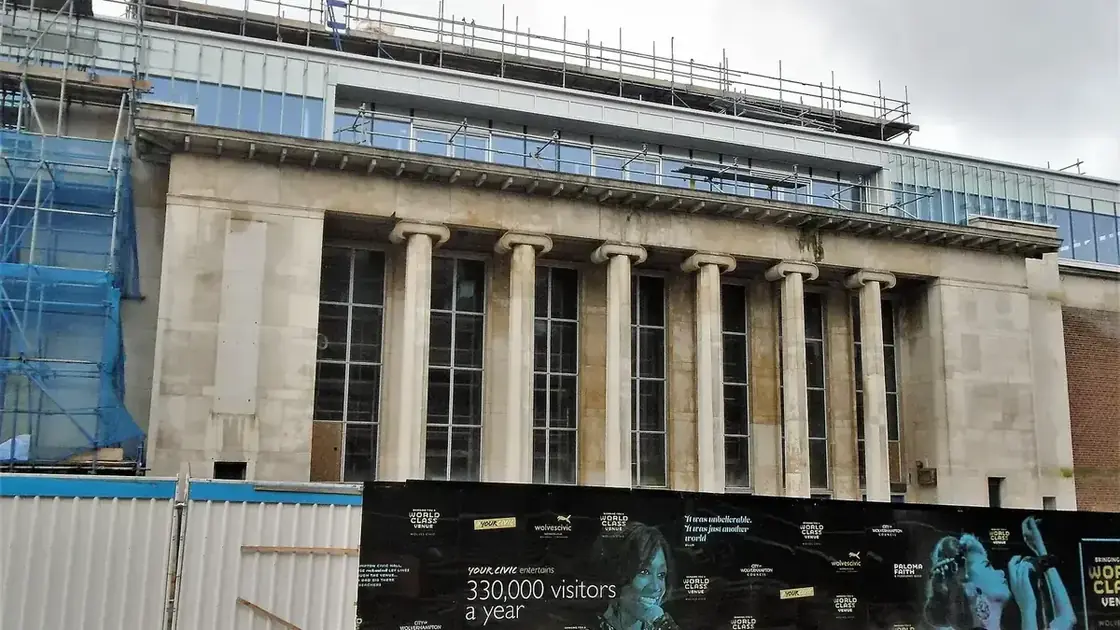 Wolverhampton Civic Hall's stone frontage during improvement work, with scaffolding and site hoarding visible.